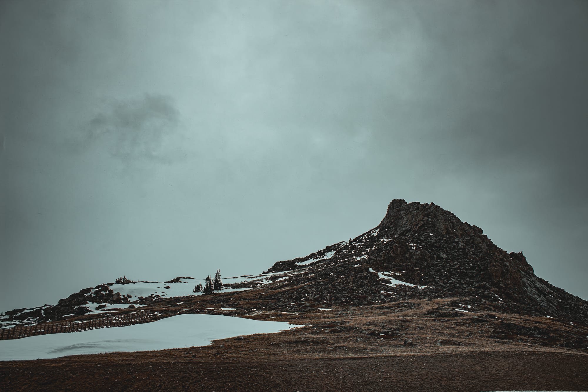 Moody snowy peak under overcast sky