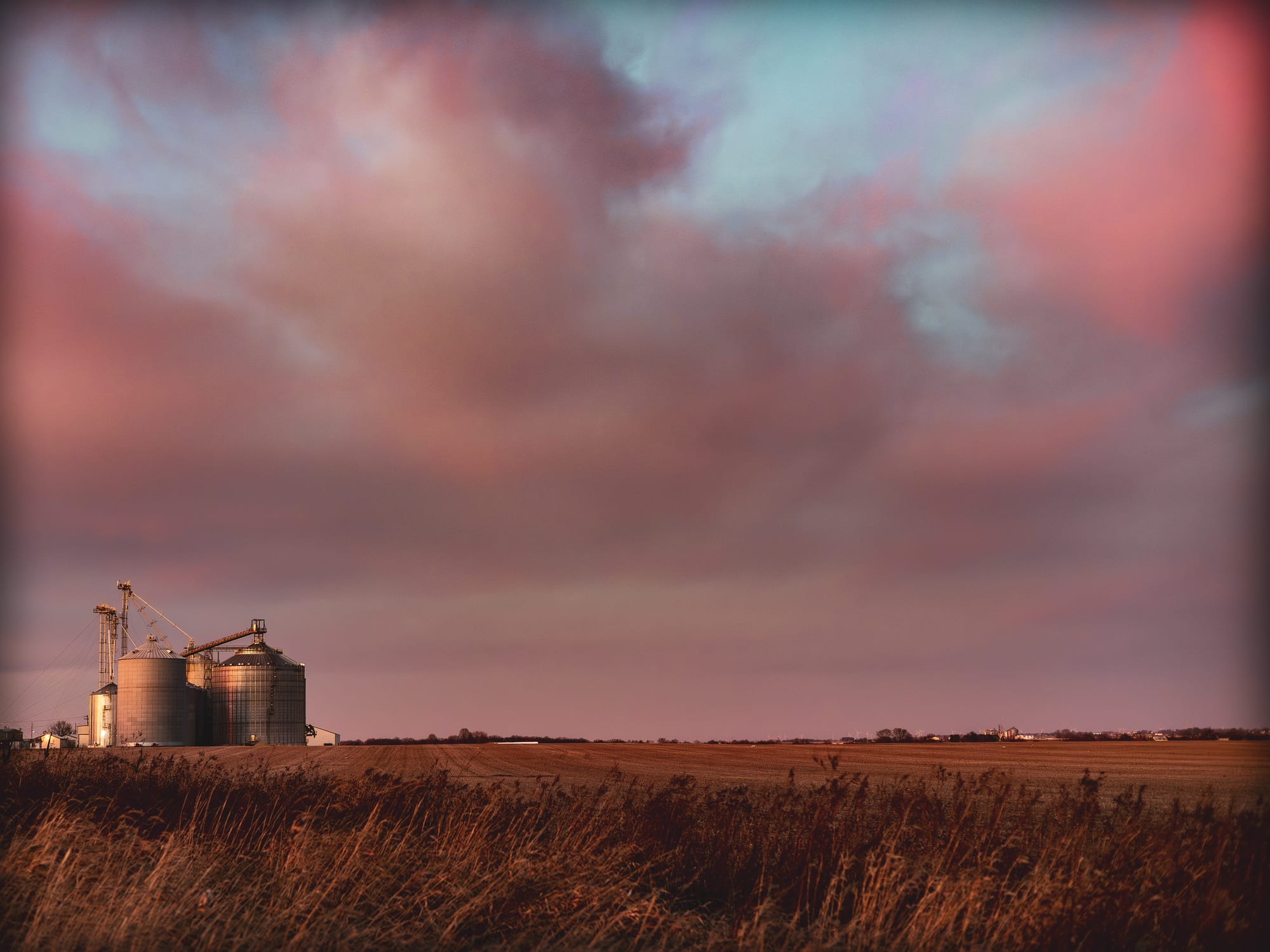 Farm silos at sunset