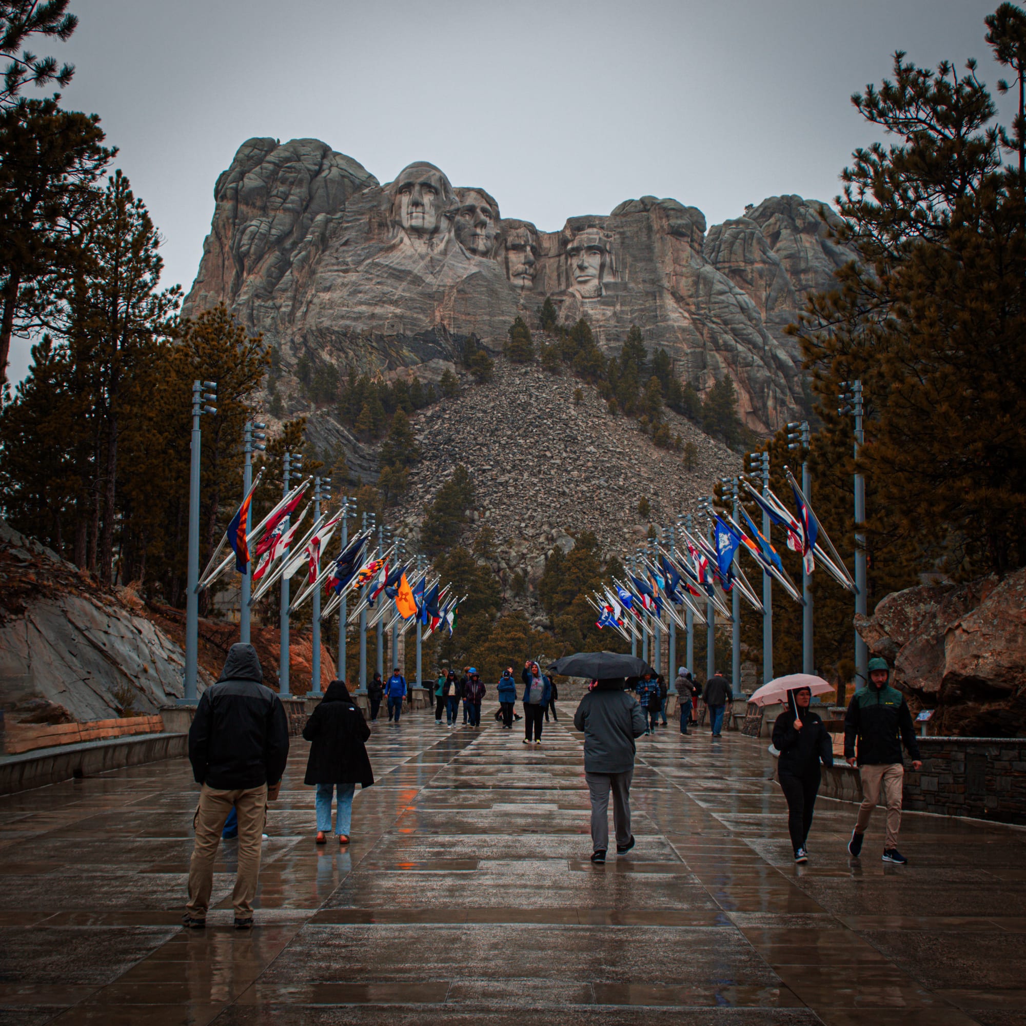 Mt. Rushmore on a rainy day with flags