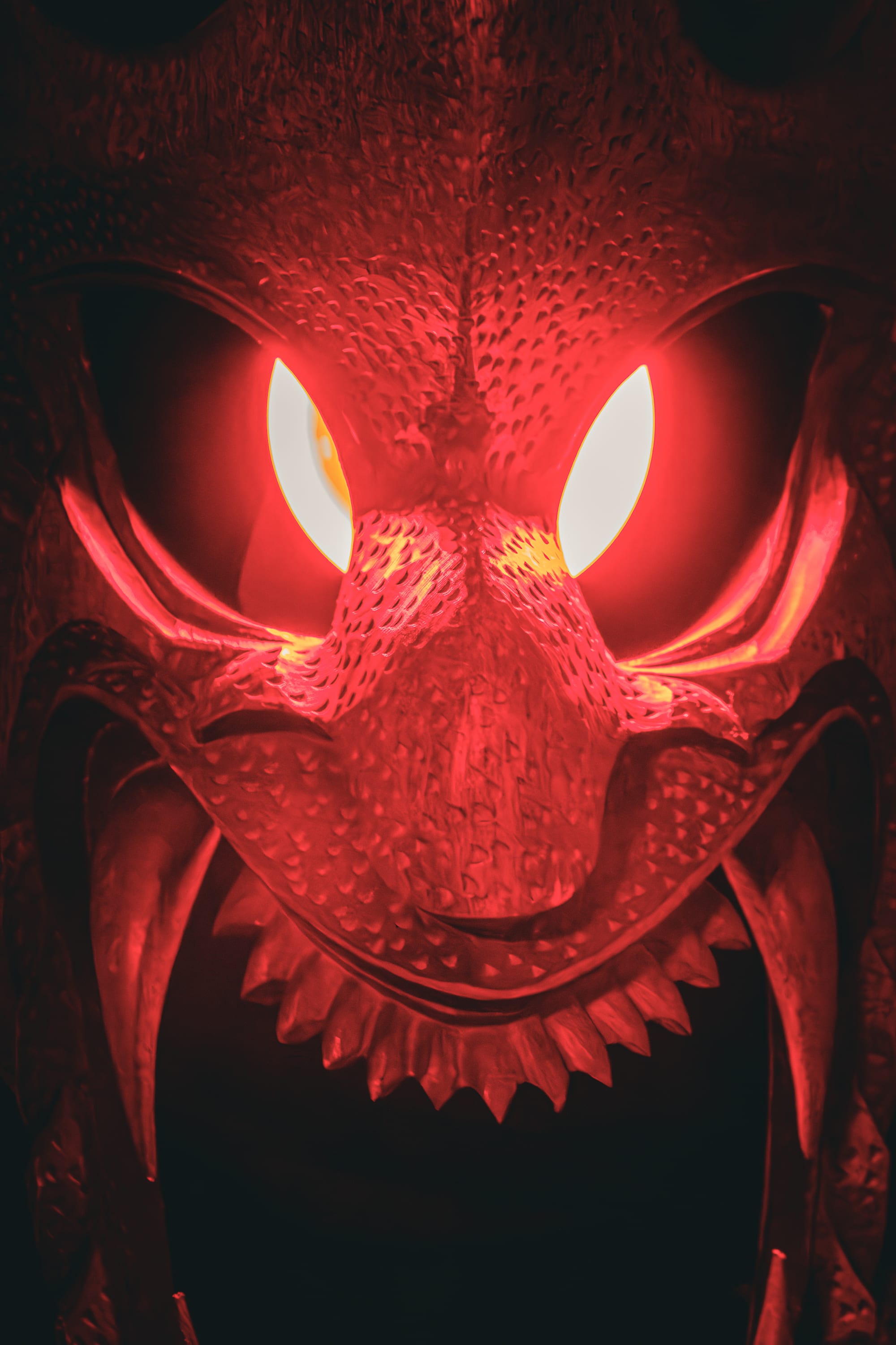Red dragon face glowing in the dark